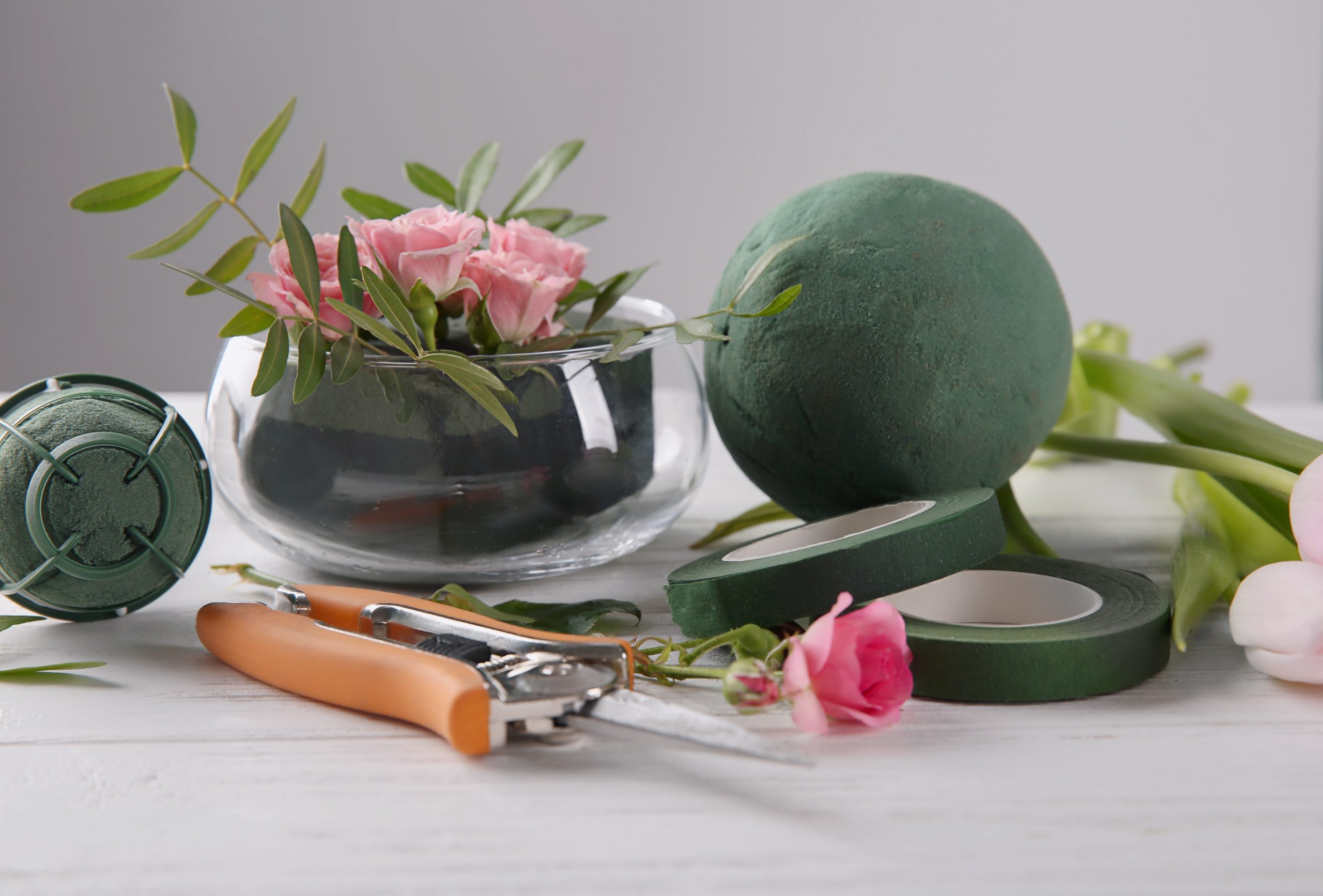 florist-equipment-with-flowers-wooden-table-min